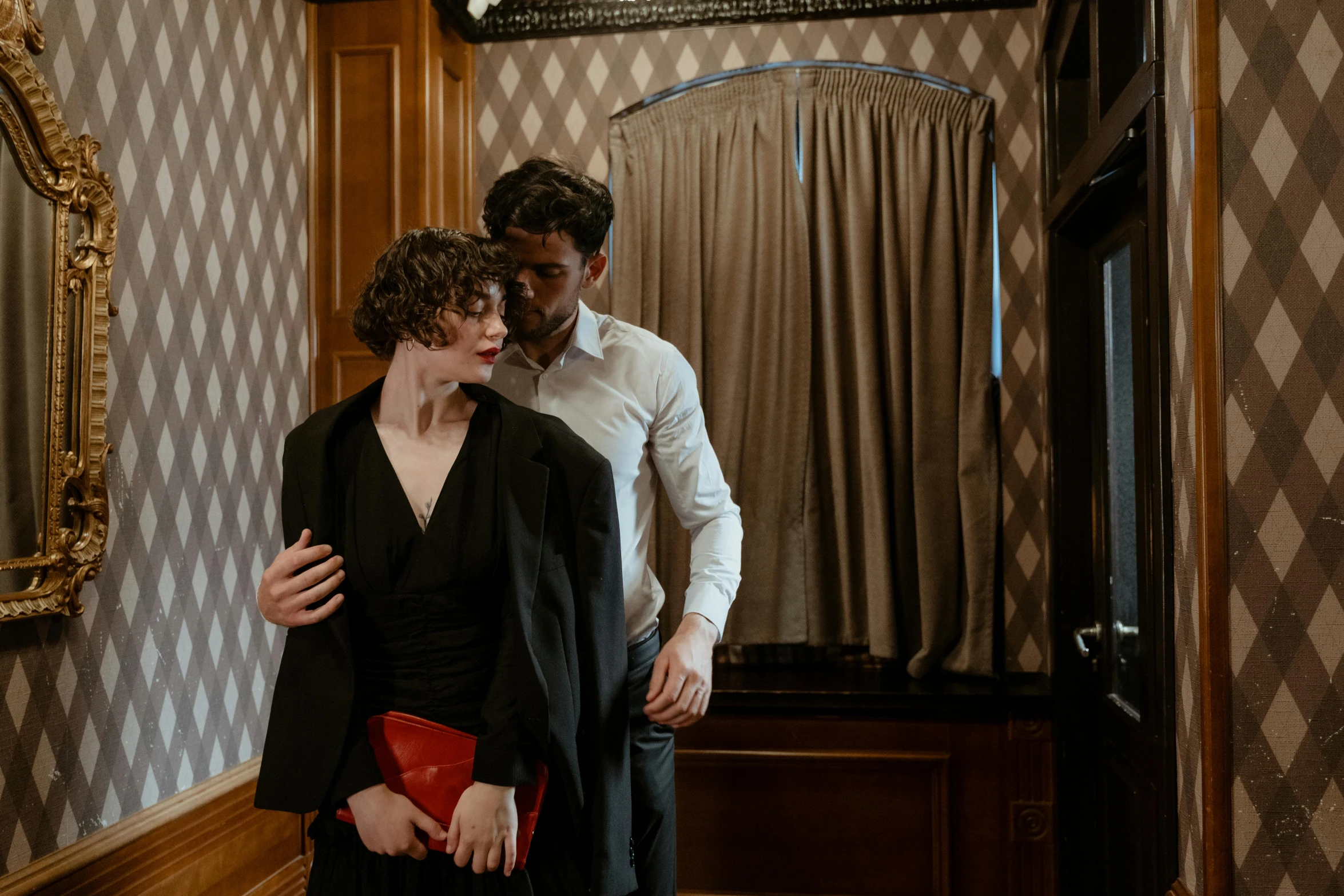 a man standing next to a woman in a room, inspired by Nan Goldin, pexels contest winner, renaissance, 1 9 2 0's style speakeasy, exiting from a wardrobe, two men hugging, ( ( theatrical ) )