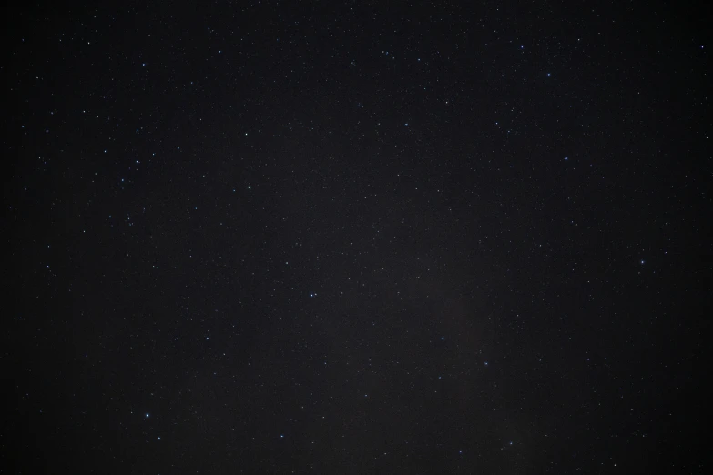 a dark sky filled with lots of stars, a picture, pexels, minimalist photo, background ( dark _ smokiness ), low quality footage, high resolution