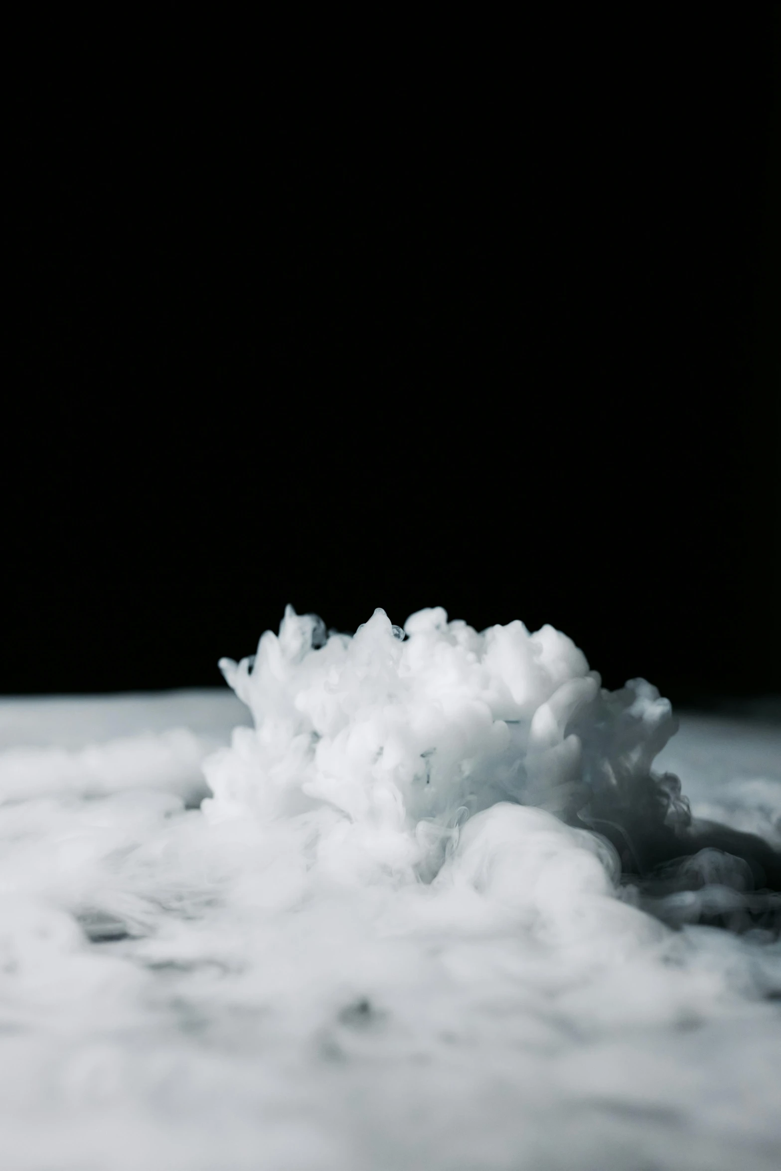 a pile of snow sitting on top of a snow covered ground, unsplash, conceptual art, cloud of smoke, mat collishaw, close up of single sugar crystal, below only cloud dark void