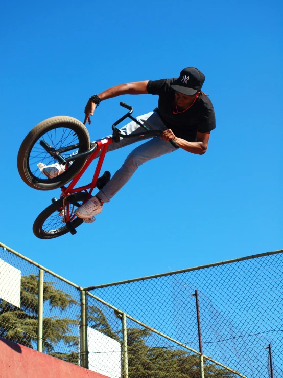 a man flying through the air while riding a bike, inspired by Seb McKinnon, jc park, upclose, sidney lugo, low quality photo