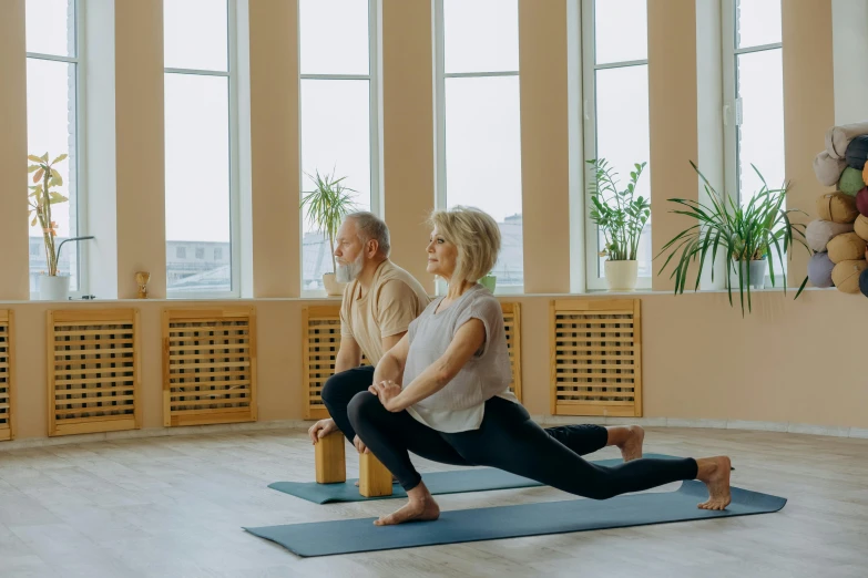 a man and a woman doing yoga together, pexels contest winner, light and space, low quality footage, two old people, thumbnail, high quality photo