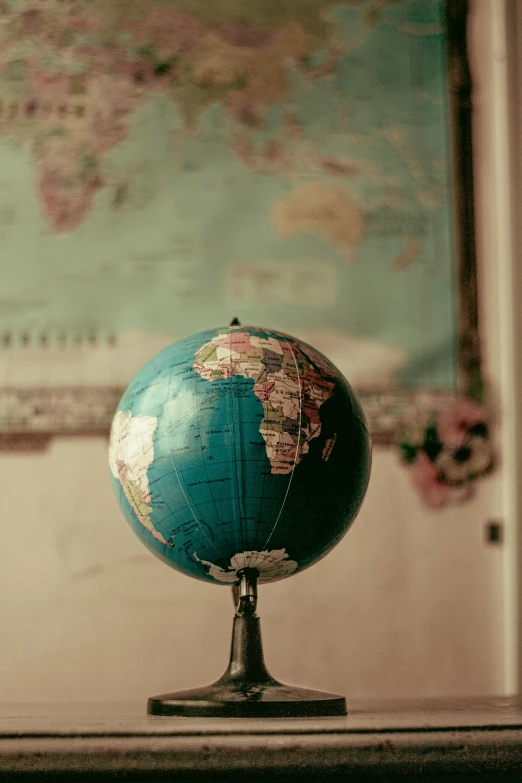 a blue globe sitting on top of a wooden table