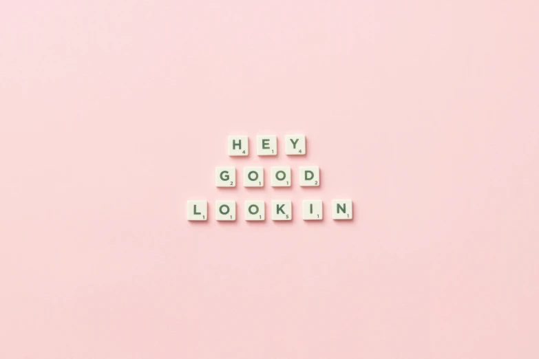 the word hey good looking spelled in scrabbles on a pink background, by Emma Andijewska, trending on pexels, aestheticism, grid of styles, photoshoot for skincare brand, on a pale background, flirting smiling