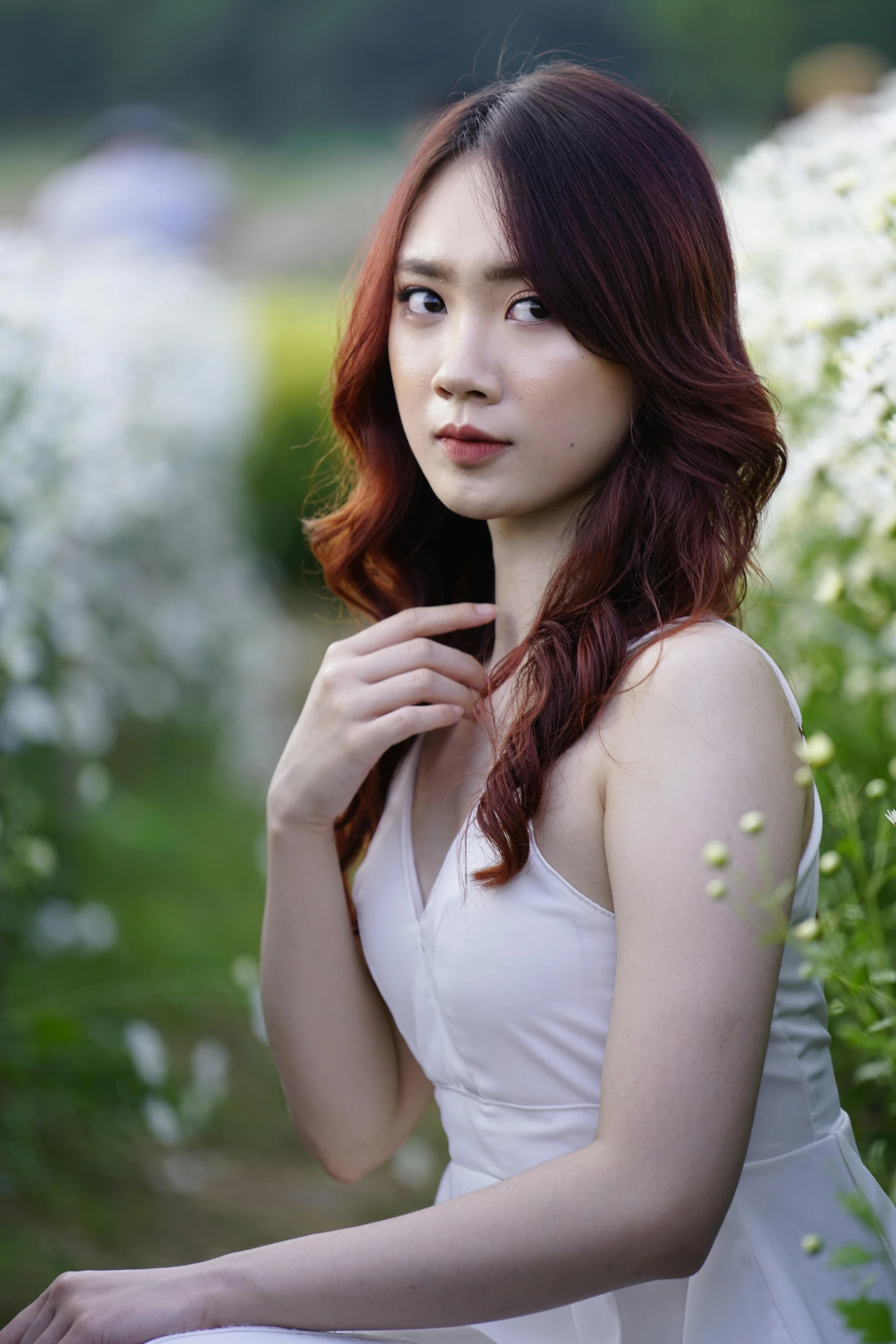 a woman sitting in a field of white flowers, inspired by Jung Park, pexels contest winner, with dark reddish hair, in style of lam manh, 🤤 girl portrait, halfbody headshot