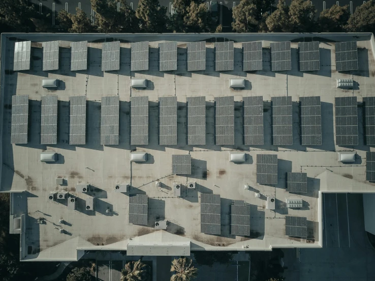 an aerial view of solar panels on the roof of a building, by Carey Morris, unsplash contest winner, cars parked underneath, shadowy area, 15081959 21121991 01012000 4k, portrait photo