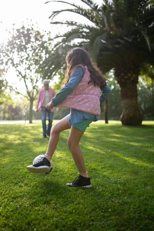 a young girl kicking a soccer ball in a park, by Robert Medley, trending on dribble, teaser, small