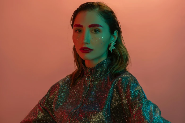 a woman with glitter on her face, an album cover, inspired by Elsa Bleda, trending on pexels, photorealism, wearing a fancy jacket, mahira khan as a d&d wizard, high red lights, official photo