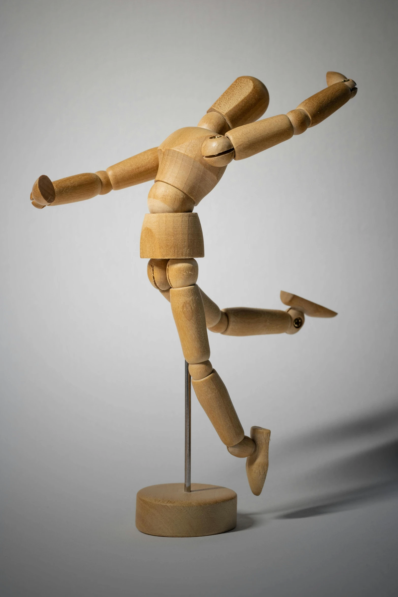 a wooden mannequin standing on a wooden base, by David Simpson, unsplash, dynamic active running pose, art toy, knee, ilustration