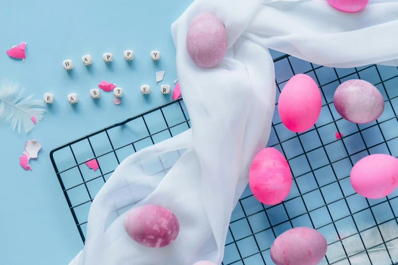 a bunch of pink balls sitting on top of a wire rack, an album cover, pexels contest winner, translucent eggs, 4k polymer clay food photography, flowing silk sheets, blue and pink colour splash