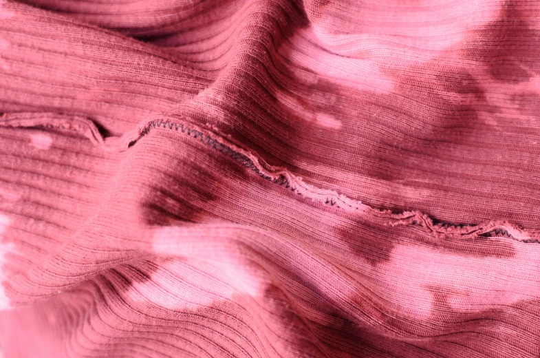 a close up of a piece of fabric, inspired by Anna Füssli, trending on pexels, pink mist, a pair of ribbed, red fluid, ripped clothing