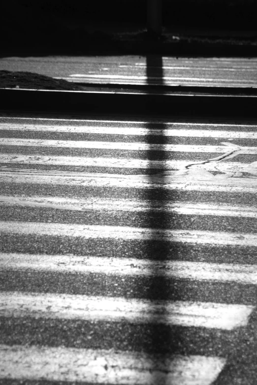 a black and white photo of a cross walk, inspired by Louis Faurer, lyrical abstraction, sunset. light shadow, square lines, stripe over eye, texturized