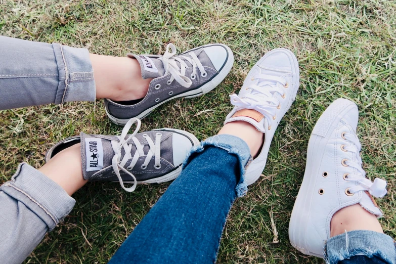 a couple of people that are standing in the grass, trending on pexels, converse, grey colours, girls resting, different sizes