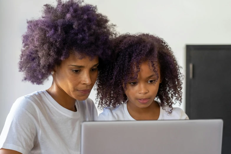 a couple of women sitting next to each other on a laptop, pexels, purple accents, kids, with afro, teaching