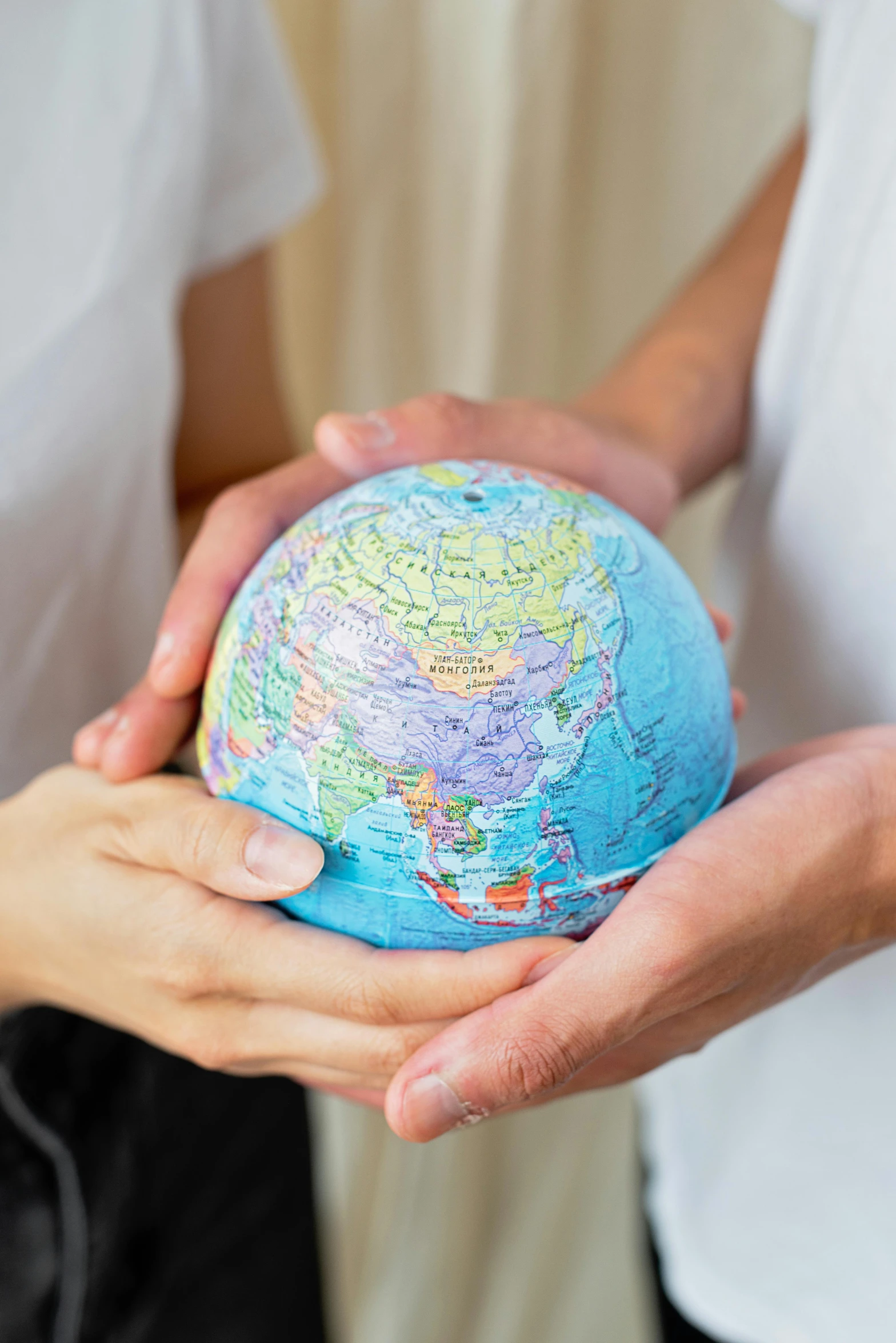 two people holding a small globe in their hands, modeled, fan favorite, center of image, thumbnail