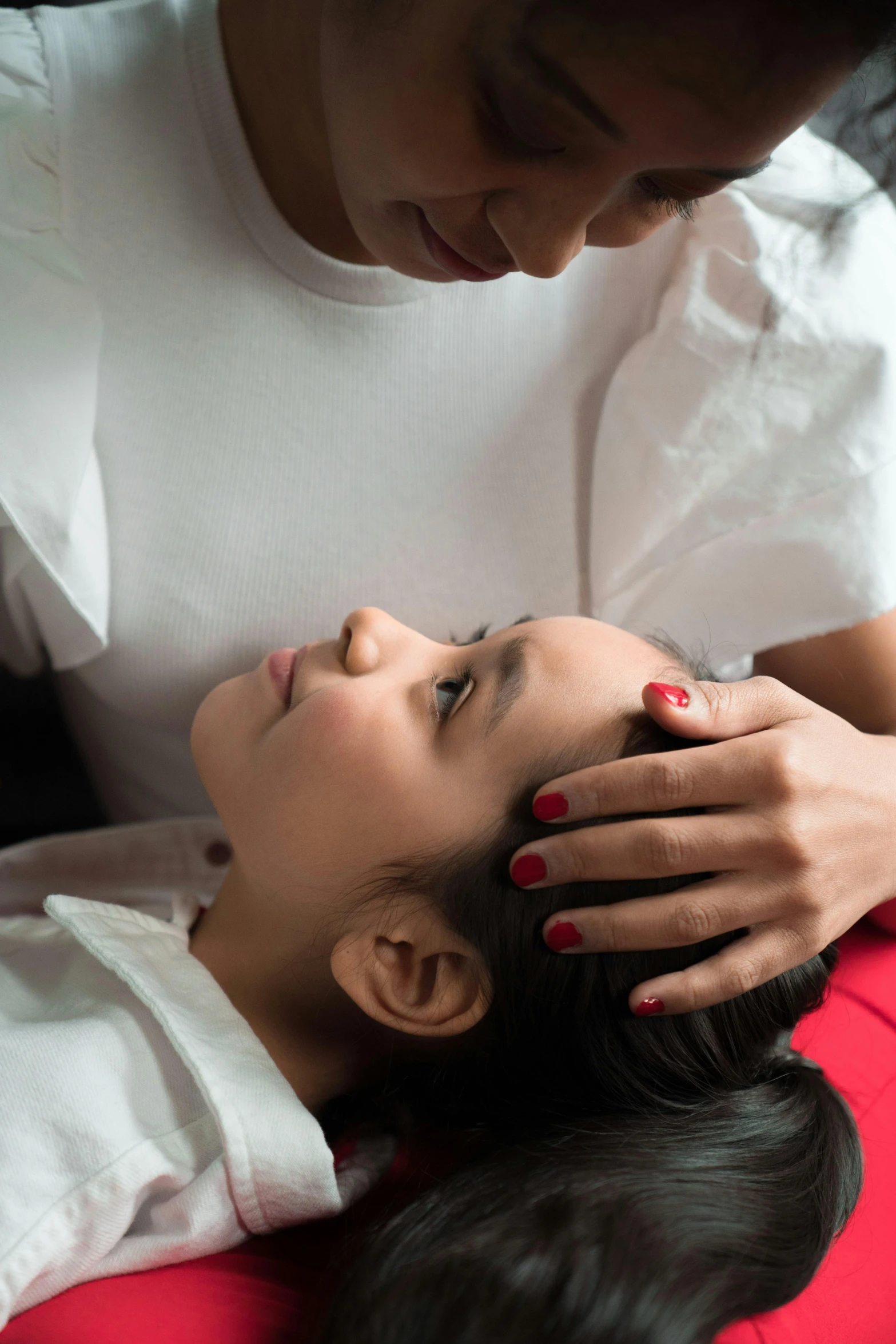 a woman laying on top of a bed next to a man, by Basuki Abdullah, eeg nodes on scalp, children's, dentist, promo