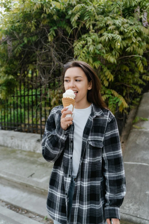 a young woman is eating an ice cream cone, pexels contest winner, renaissance, wearing plaid shirt, alexandria ocasio cortez, 1 2 9 7, outdoor photo