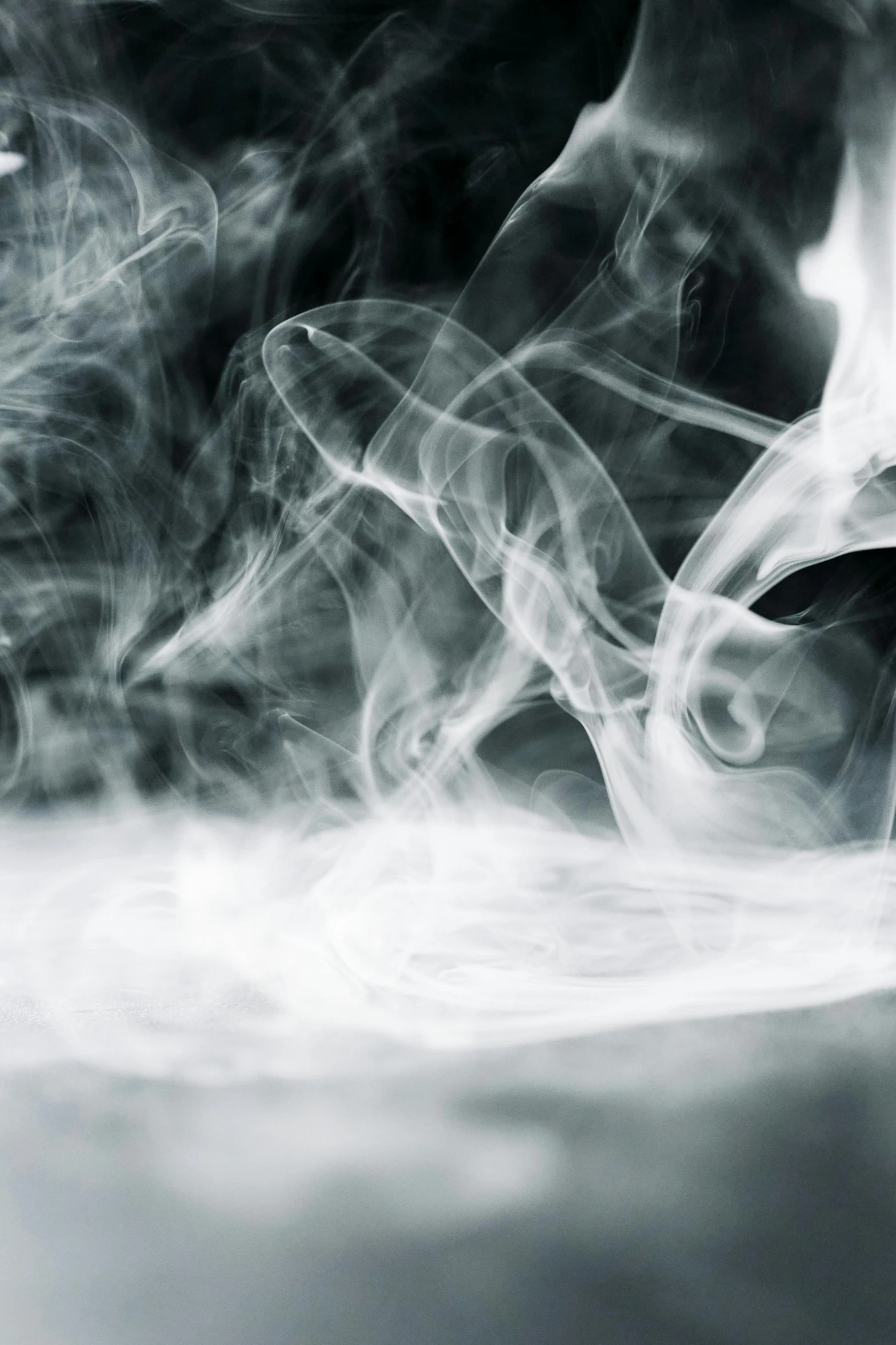 a black and white photo of smoke in the air, pexels contest winner, lyrical abstraction, incense, desaturated, ((mist)), swirly smoke