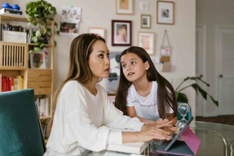 a woman and a little girl sitting at a table, a cartoon, pexels contest winner, future coder looking on, pokimane, focused photo, 1 4 9 3