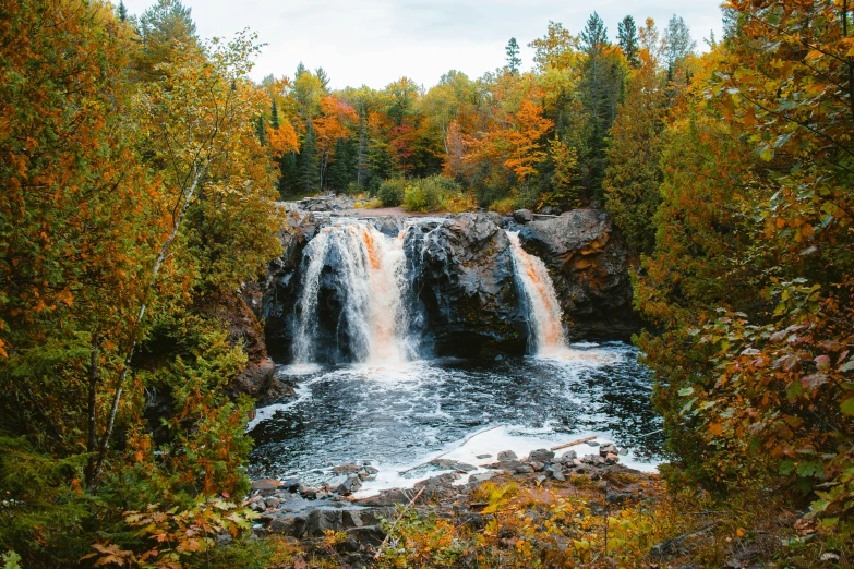 a waterfall in the middle of a forest, in fall, boreal forest, instagram post, slide show