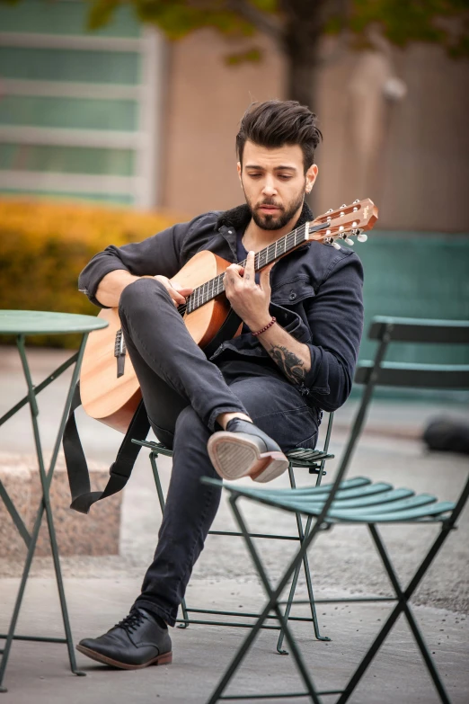 a man sitting on a chair playing a guitar, inspired by Nadim Karam, pexels contest winner, zayn malik, square, attractive, headshot