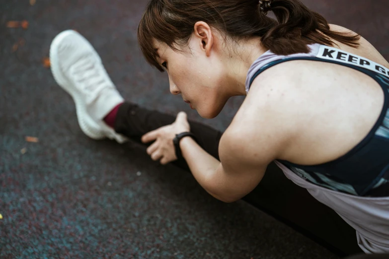 a woman sitting on the ground with her feet on the ground, pexels contest winner, shin hanga, working out, crying and reaching with her arm, high angle close up shot, thumbnail