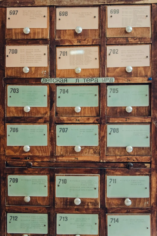 a wooden cabinet filled with lots of drawers, an album cover, by Konrad Witz, unsplash, private press, post - soviet courtyard, delivering mail, 1792, lockers