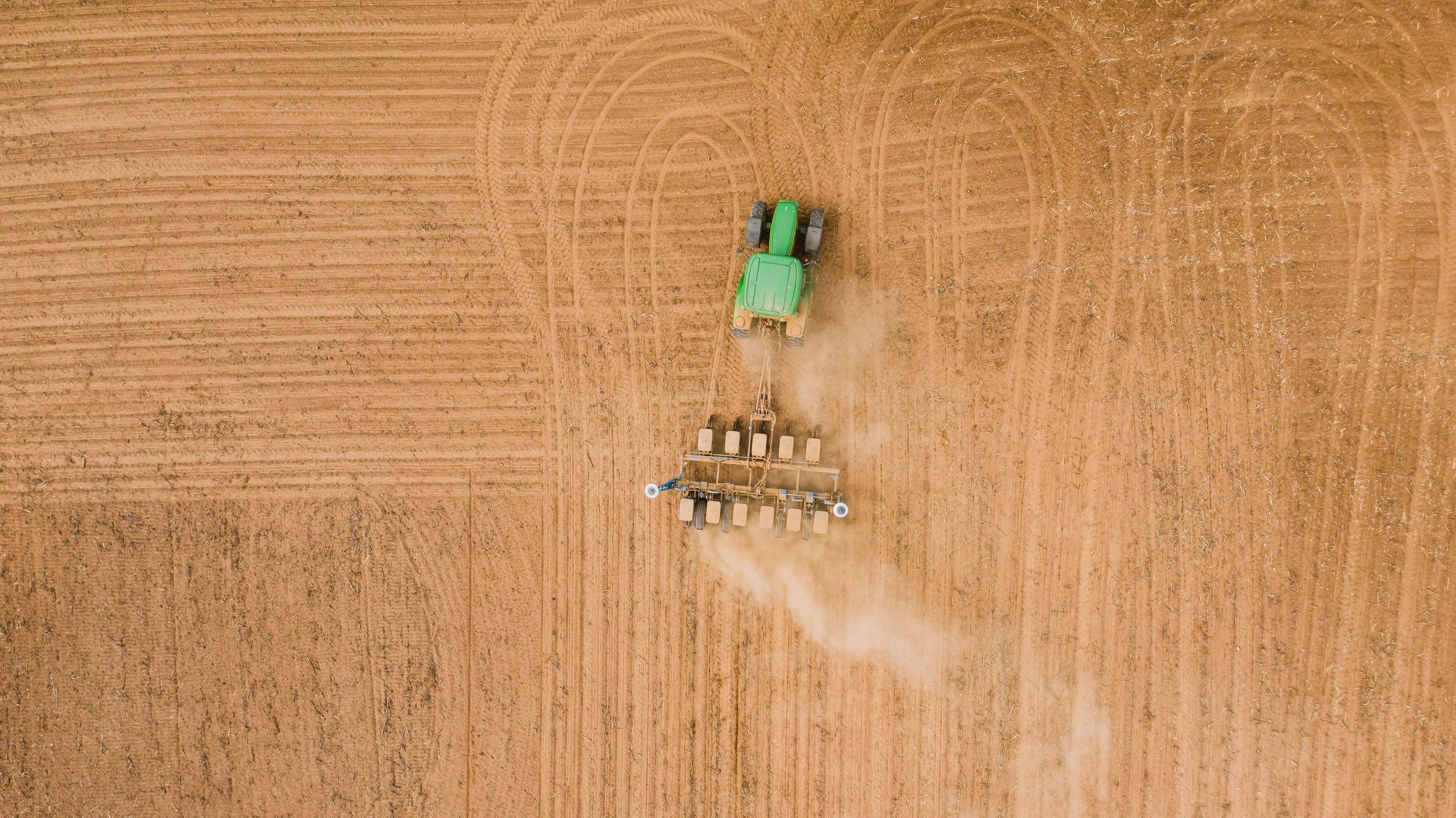 an aerial view of a tractor plowing a field, unsplash contest winner, figuration libre, faded and dusty, fan favorite, australia, seeds