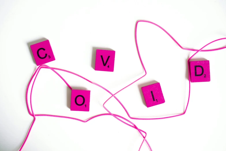 a couple of pink letters sitting on top of a pink string, inspired by Cerith Wyn Evans, pexels contest winner, coward, cubes, good vs evil, cover corp