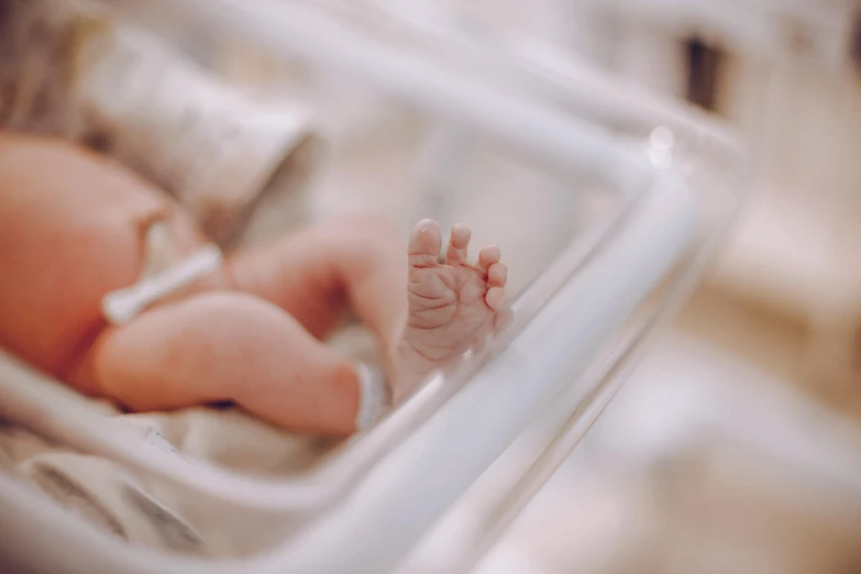 a baby in an inc inc inc inc inc inc inc inc inc inc inc inc inc inc inc inc inc inc inc inc inc inc inc inc, by Daniel Lieske, pexels contest winner, symbolism, in hospital bed, incubator medpods, detailed close foot shot, profile image