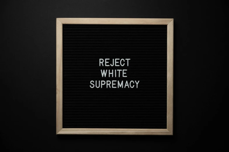 a black letter board with the words reject white supremacy, inspired by Carrie Mae Weems, unsplash contest winner, suprematism, cinematic. white, sup, sus