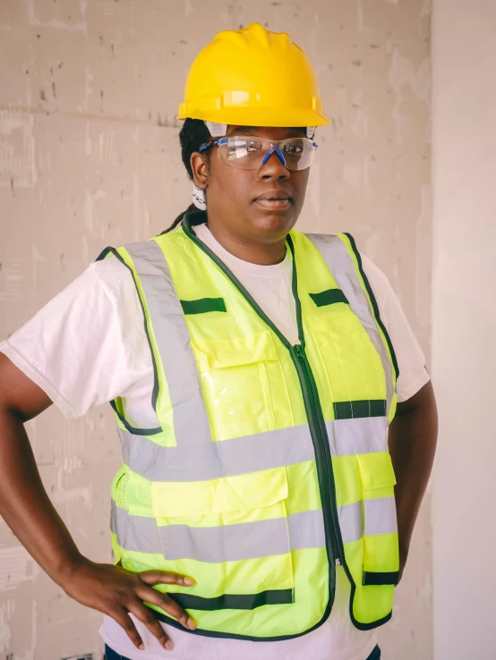 a woman wearing a hard hat and safety vest, by Louisa Puller, wearing gold glasses, godwin akpan, lgbtq, chunky build