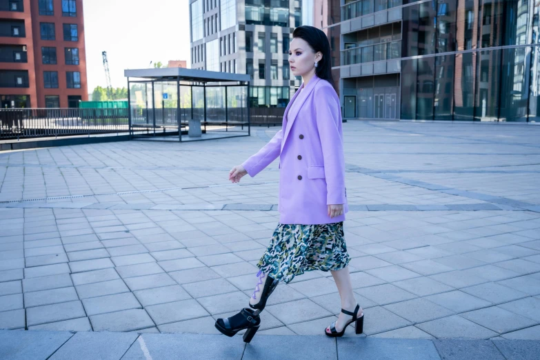 a woman walking across a sidewalk in a purple coat, pexels, bauhaus, wearing jacket and skirt, aurora aksnes, paisley, alina ivanchenko