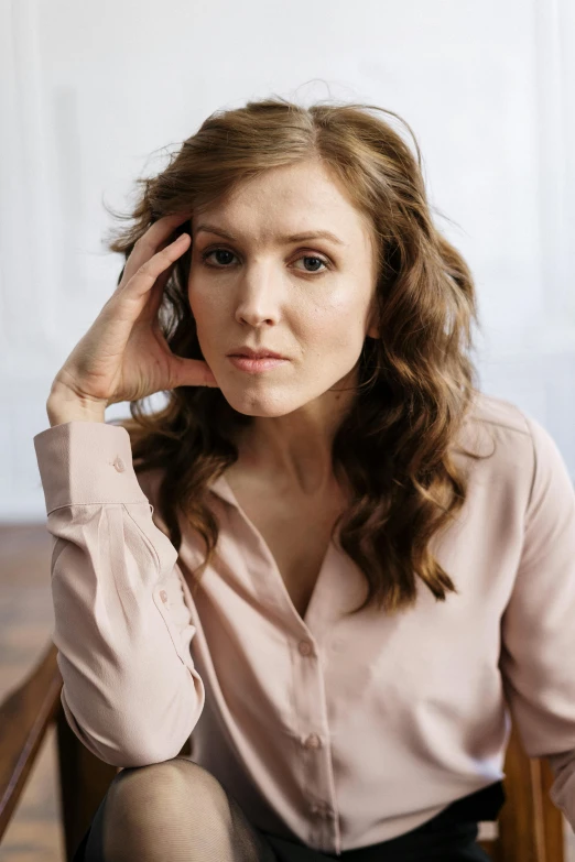 a woman sitting in a chair talking on a cell phone, a portrait, trending on pexels, renaissance, elizabeth olsen, concerned expression, attractive brown hair woman, maternal