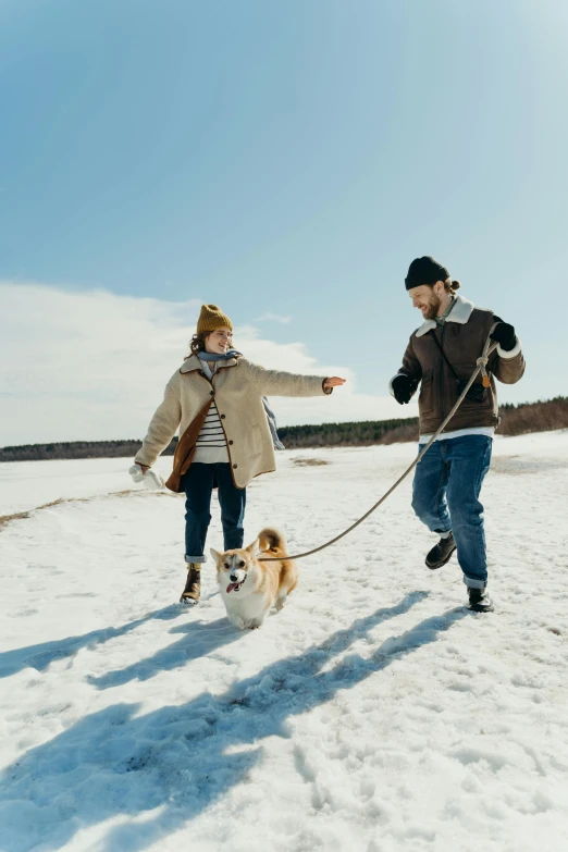 a man and woman walking a dog in the snow, pexels contest winner, renaissance, electric cats that fly over ice, picnic, 256435456k film, manuka