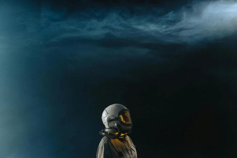 a man standing on top of a snow covered slope, an album cover, by Adam Marczyński, unsplash contest winner, light and space, space suit with a modern helmet, in front of dark smoke, profile picture, night sky