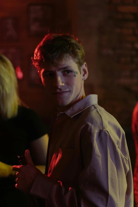 a man standing next to a woman at a party, flickr, he looks like tye sheridan, shot from cinematic, ( ( theatrical ) ), 15081959 21121991 01012000 4k