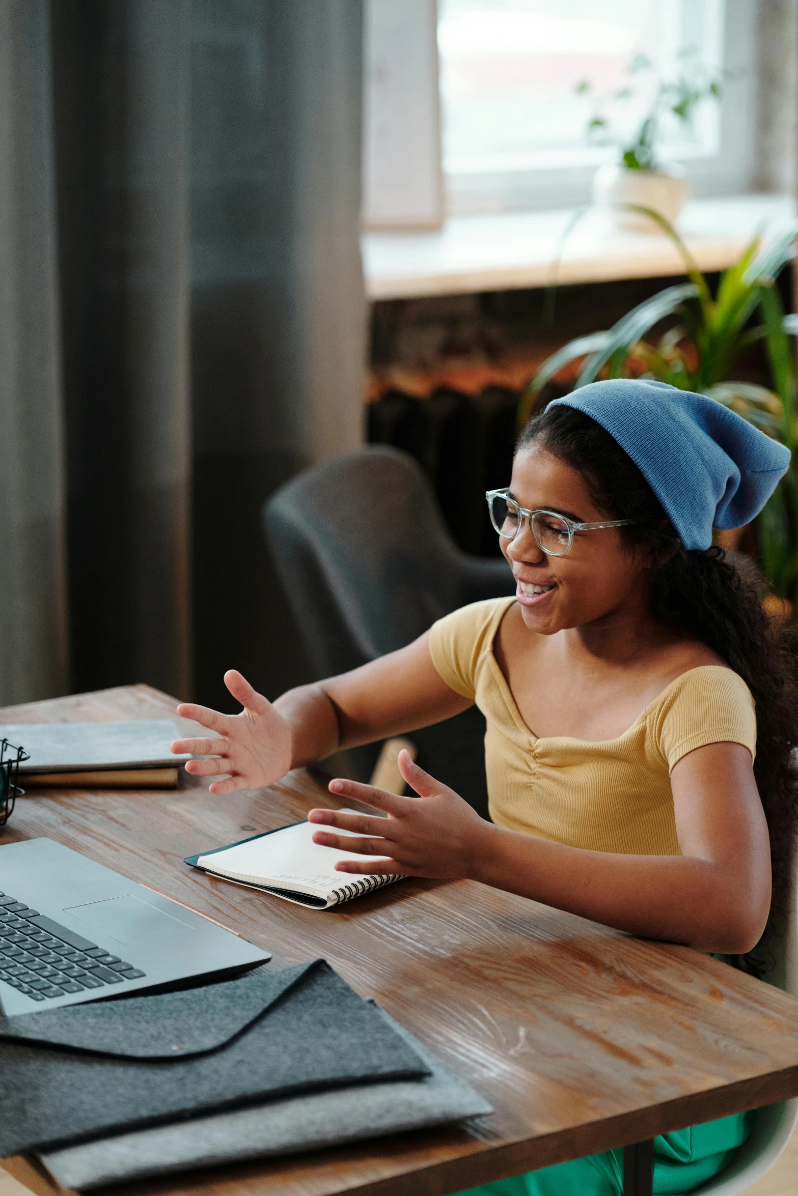 a little girl sitting at a table with a laptop, trending on pexels, renaissance, wearing teal beanie, black teenage girl, excited, thumbnail