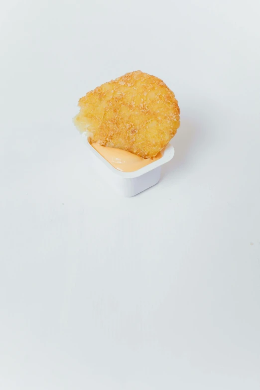 a piece of food sitting on top of a white table, reddit, chicken nuggets, low quality photo, (cheese), humus