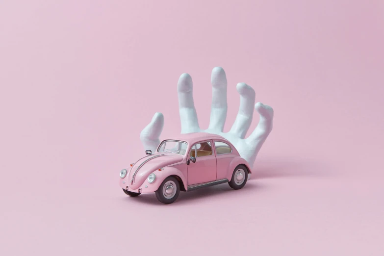 a pink toy car sitting on top of a hand, a surrealist sculpture, inspired by Chris LaBrooy, pexels contest winner, magic realism, hands with five fingers, beetle, dribbble, made of cotton candy