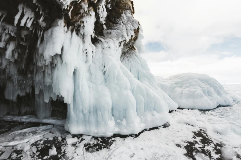 a man standing on top of a snow covered rock, dripping stalagtites, unsplash transparent, thumbnail, bushy white beard