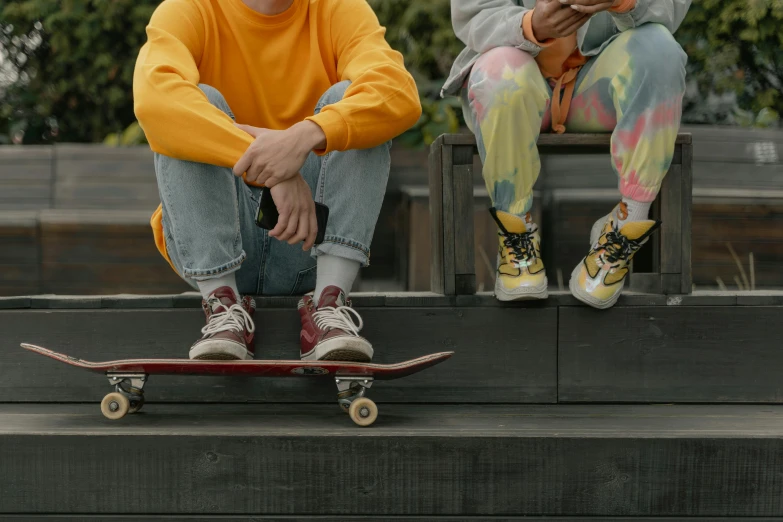 a couple of people that are sitting on a skateboard, trending on pexels, hyperrealism, scarlet and yellow scheme, federation clothing, childhood friend vibes, bench