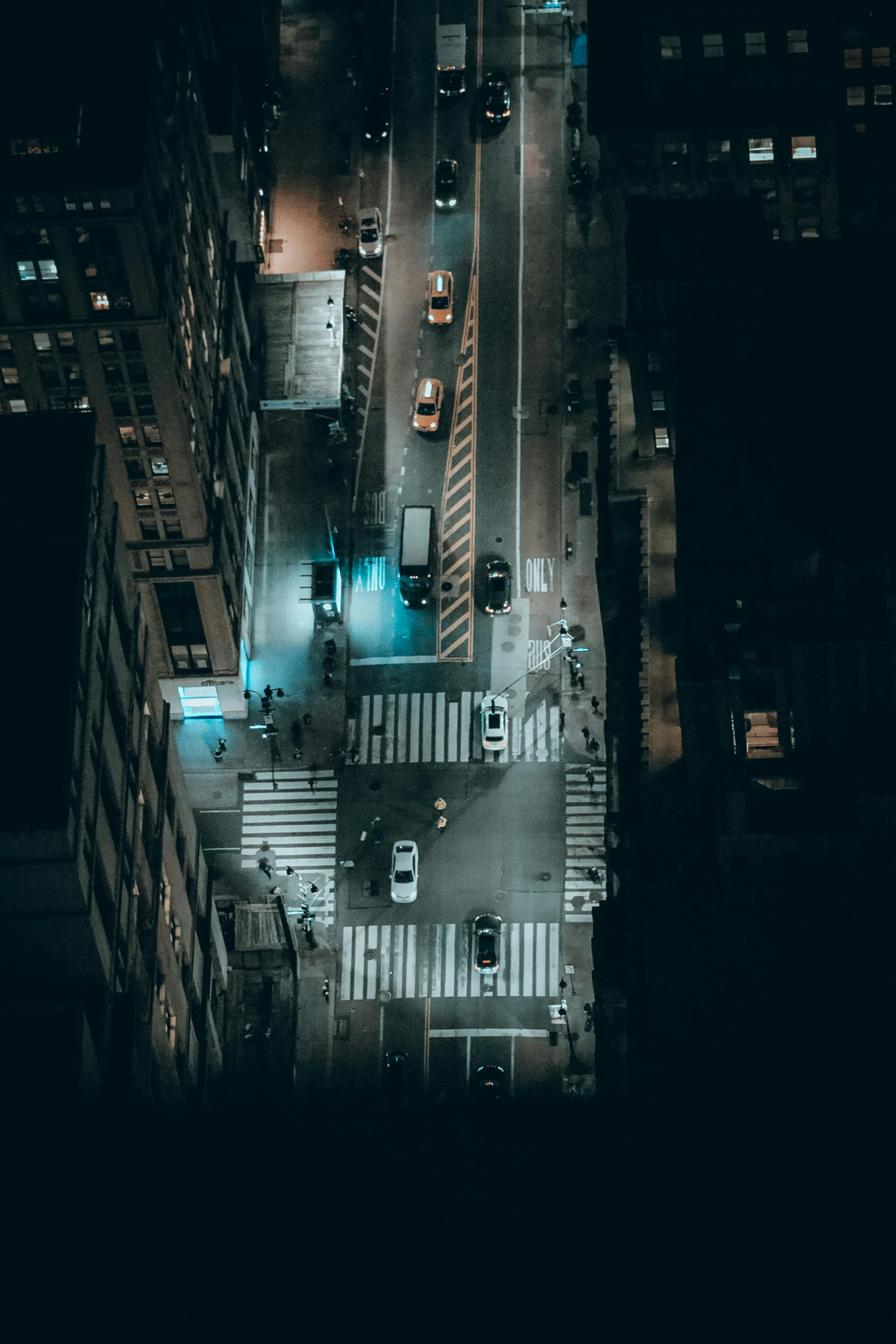 an aerial view of a city street at night, pexels contest winner, new york streets, crosswalk, high quality photo, late morning