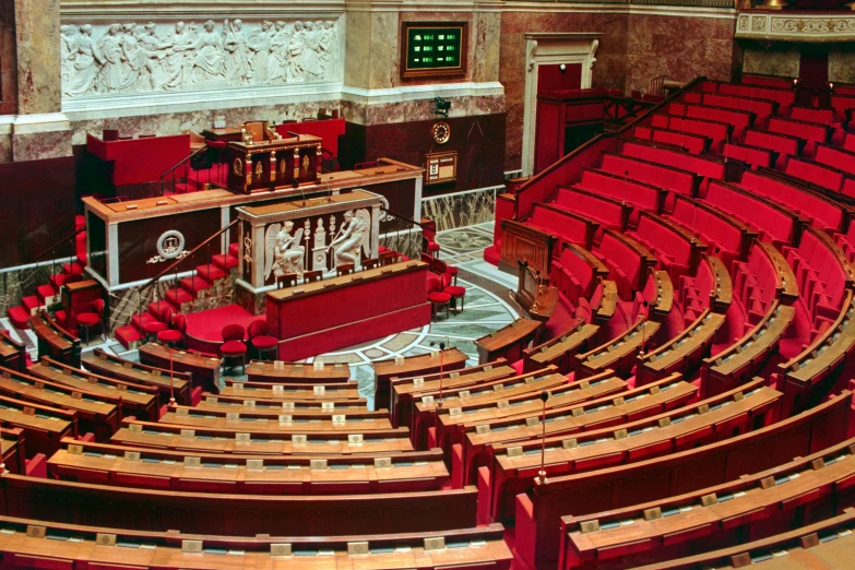 a large room filled with lots of red chairs, by Bernard Meninsky, the city of paris, state of the union, 90s photo, listing image