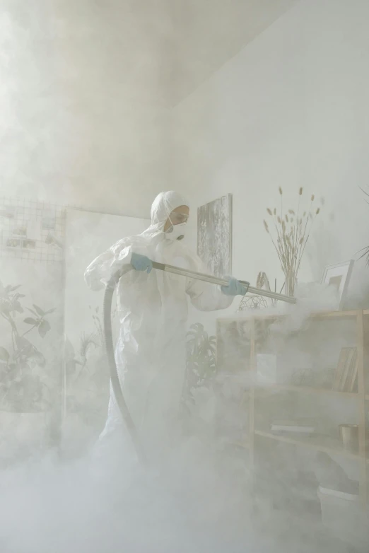 a man that is standing in a room with a hose, by artist, pexels contest winner, process art, dust mask, wearing a labcoat, photorealistic cinematic render, decoration