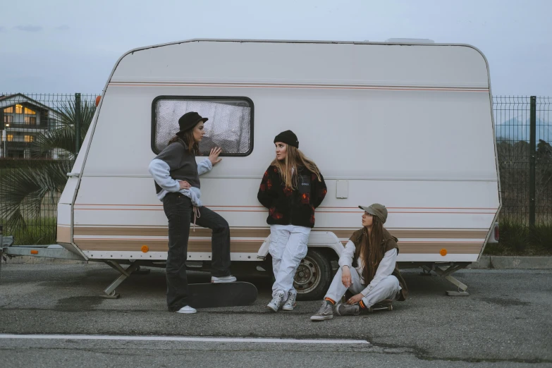 a group of people sitting in front of a camper, by Emma Andijewska, pexels contest winner, realism, woman in streetwear, 15081959 21121991 01012000 4k, three women, standing in road