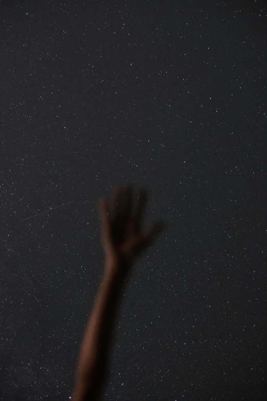 a person reaching up to catch a frisbee, by Attila Meszlenyi, unsplash contest winner, light and space, black sky full of stars, brown skin like soil, closeup of arms, dark. no text