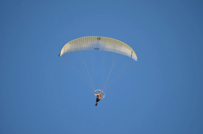 a person that is in the air with a parachute, a portrait, flickr, avatar image, clear blue skies, taken with sony alpha 9, ornithopter