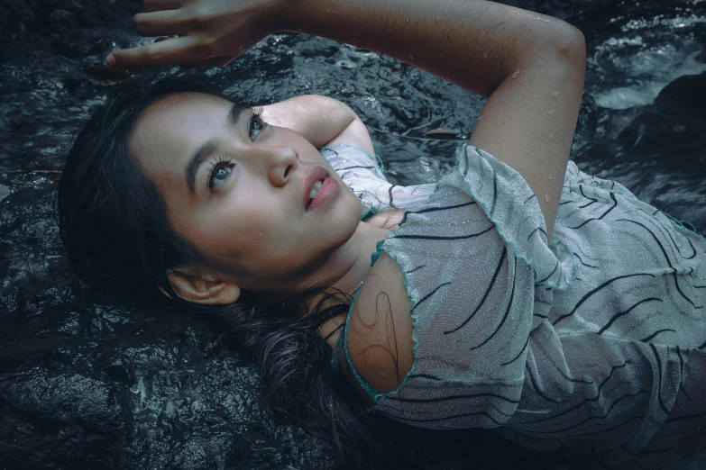 a woman laying on a rock in the water, by Adam Marczyński, pexels contest winner, hyperrealism, young asian woman, wet face, gif, cinematic outfit photo