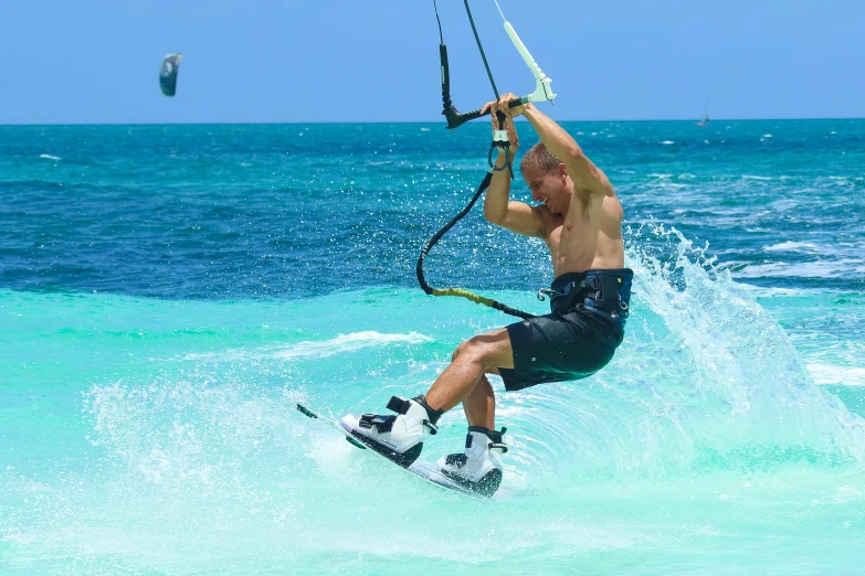 a man riding a wave on top of a surfboard, kites, sassy pose, aruba, wielding a whip