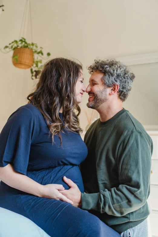 a man and a woman are sitting on a bed, profile image, maternity feeling, rebecca sugar, taken in 2 0 2 0